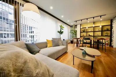 a living room with a couch and a table at Pufuka Inn Skytree in Tokyo
