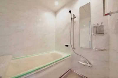 a white bathroom with a tub and a shower at Pufuka Inn Skytree in Tokyo