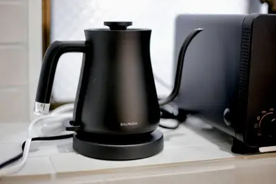 a black coffee maker sitting on a counter next to a computer at Pufuka Inn Skytree in Tokyo