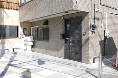 a brick building with a black door on it at Pufuka Inn Skytree in Tokyo