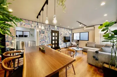 a living room with a table and a couch at Pufuka Inn Skytree in Tokyo