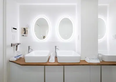 a bathroom with two sinks and two mirrors at Hostel JAZ in Tokyo