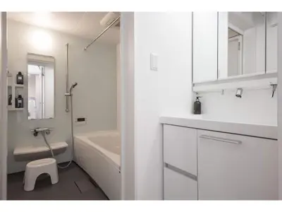 a white bathroom with a tub and a sink and a toilet at Private Hotel Oshiage - Vacation STAY 81630v in Tokyo