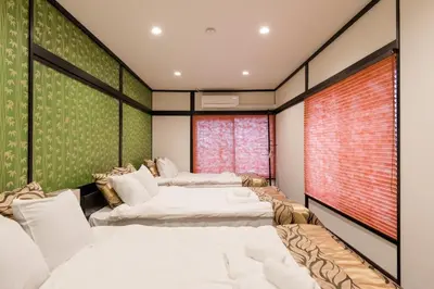 a room with three beds and a window at Asakusa SAKURA-RYOKAN - Vacation STAY 88198v in Tokyo