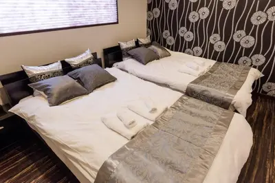 two beds sitting next to each other in a bedroom at Asakusa SAKURA-RYOKAN - Vacation STAY 88198v in Tokyo