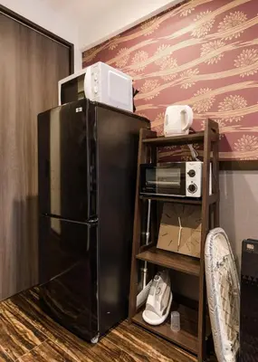 a black refrigerator with a microwave on top of it at Asakusa SAKURA-RYOKAN - Vacation STAY 88198v in Tokyo