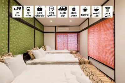 two beds in a room with signs on the wall at Asakusa SAKURA-RYOKAN - Vacation STAY 88198v in Tokyo