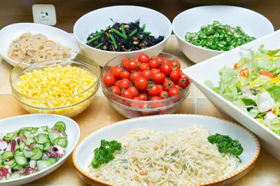 a table topped with bowls of different types of food at Pearl Hotel Kayabacho in Tokyo