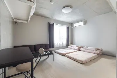 a living room with a bed and a table at Marvelous Koiwa - Vacation STAY 90812v in Tokyo