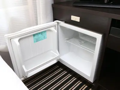 an empty refrigerator with its door open in a kitchen at APA Hotel & Resort Roppongi Ekihigashi in Tokyo