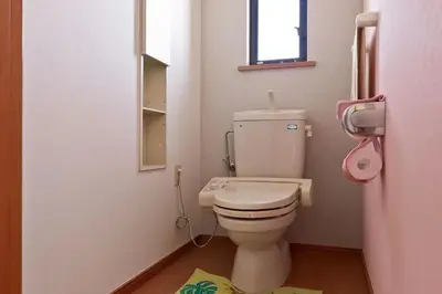 a small bathroom with a toilet and a window at japan house shinkoiwa guest house in Tokyo