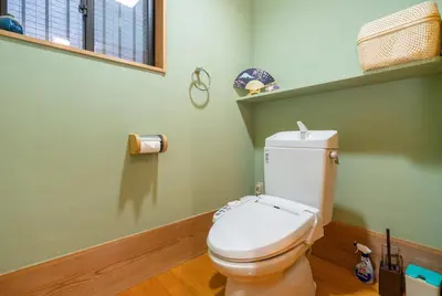 a bathroom with a white toilet in a green room at Japanese traditional house.Ryokan in asakusa with 2bedrooms in Tokyo
