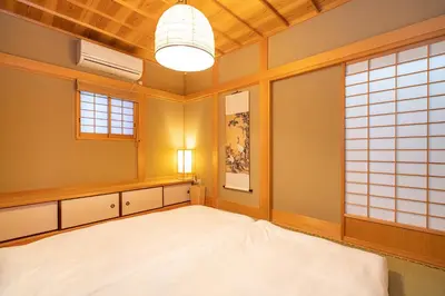 a room with a large white bed in it at Japanese traditional house.Ryokan in asakusa with 2bedrooms in Tokyo