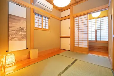 a room with orange walls and windows and a rug at Japanese traditional house.Ryokan in asakusa with 2bedrooms in Tokyo