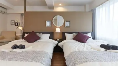 a bedroom with three beds with pillows on them at HOTEL ESTASIA Ryogoku - Vacation STAY 98929v in Tokyo