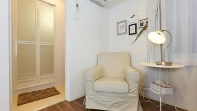 a living room with a chair and a lamp at HOTEL ESTASIA Ryogoku - Vacation STAY 98929v in Tokyo