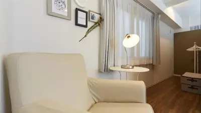 a living room with a white chair and a lamp at HOTEL ESTASIA Ryogoku - Vacation STAY 98929v in Tokyo