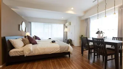a bedroom with a bed and a desk and a dining room at HOTEL ESTASIA Ryogoku - Vacation STAY 98929v in Tokyo