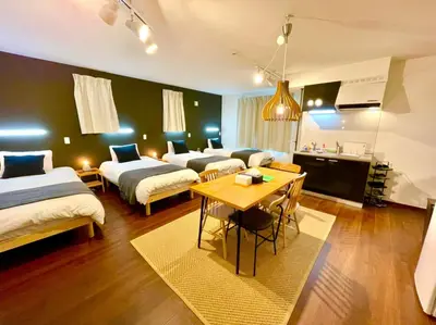 a room with three beds and a table in it at Sumida-ku - House - Vacation STAY 86935v in Tokyo