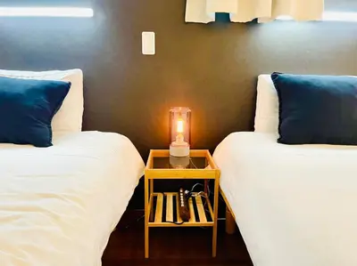 two beds in a room with a candle on a table at Sumida-ku - House - Vacation STAY 86950v in Tokyo