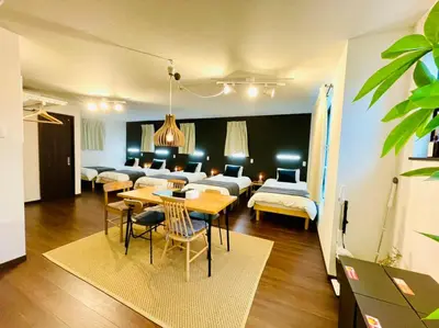 a living room with a table and a room with beds at Sumida-ku - House - Vacation STAY 86950v in Tokyo