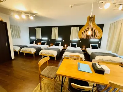 a room with four beds and a table and chairs at Sumida-ku - House - Vacation STAY 86950v in Tokyo