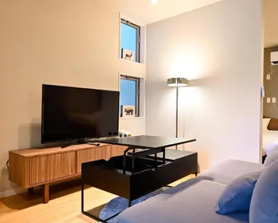a living room with a flat screen tv on a table at Hotel AZUMA SEE in Tokyo
