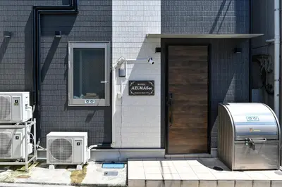 a front door of a house with an air conditioner at Hotel AZUMA SEE in Tokyo