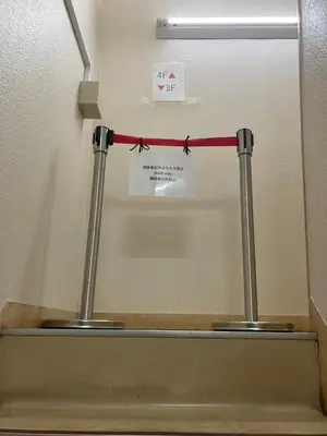 a red ribbon is hanging over a urinal in a bathroom at AN HOTEL in Tokyo