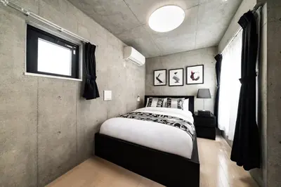 a bedroom with a large bed and a window at Shinjuku area Industrial Chic apartment Walk 6min To Station in Tokyo