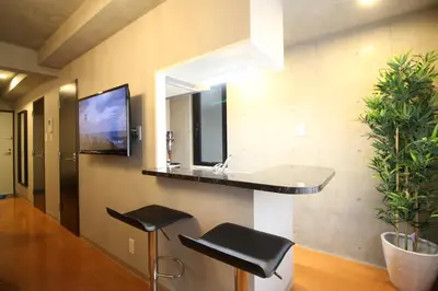 a bathroom with a sink and a mirror and stools at Shinjuku area Industrial Chic apartment Walk 6min To Station in Tokyo