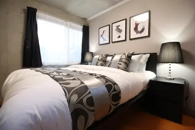 a bedroom with a large bed and a window at Shinjuku area Industrial Chic apartment Walk 6min To Station in Tokyo