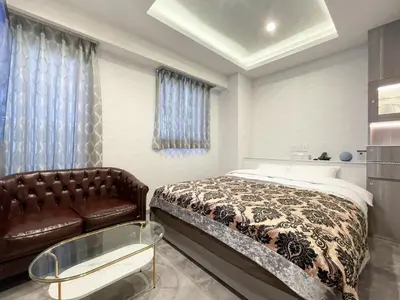 a bedroom with a bed and a couch at Hotel DIAMOND in Tokyo
