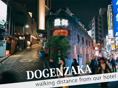 a city street at night with people walking down the street at Hotel DIAMOND in Tokyo