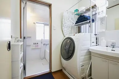 a bathroom with a washing machine and a sink at Shinjuku area house with 3BR 2mins to Metro on foot in Tokyo