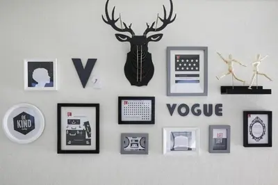 a wall with pictures and a deer head on it at Shinjuku area house with 3BR 2mins to Metro on foot in Tokyo