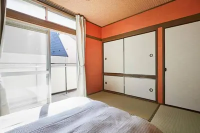 a bedroom with a bed and a large window at Shinjuku area house with 3BR 2mins to Metro on foot in Tokyo