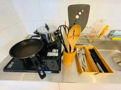 a stove with a pot on it next to a sink at SALON\u6e0b\u8c375B in Tokyo