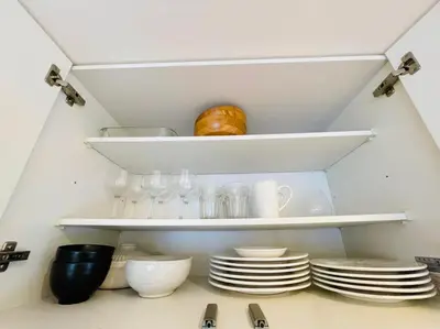 a closet with plates and cups and dishes on shelves at SALON\u6e0b\u8c375B in Tokyo