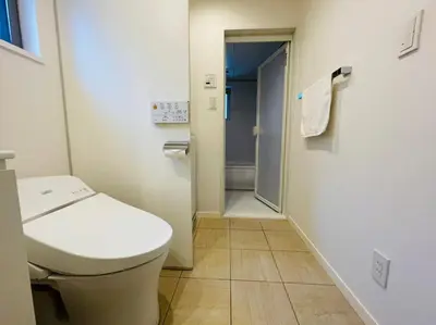 a bathroom with a toilet and a door to a shower at SALON\u6e0b\u8c375B in Tokyo