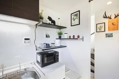 a kitchen with a sink and a microwave at Shinkoiwa house at JR line.Easy to airport&Disney. in Tokyo