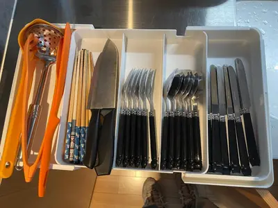 a white container filled with utensils on a table at Nplus Tokyo Akihabara Premium in Tokyo