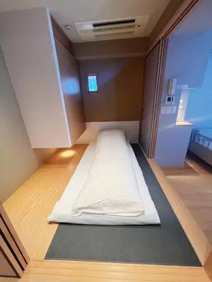 a mattress in an empty room with a bed in it at Nplus Tokyo Akihabara Premium in Tokyo