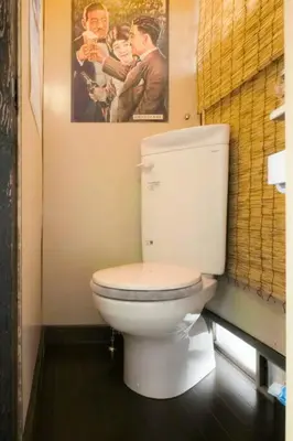 a bathroom with a toilet with a picture on the wall at Konoha house【Japanese-style guest house near Asakusa & Skytree】 in Tokyo
