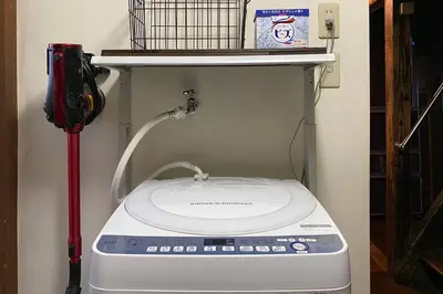 a washing machine in a room with a shelf at Konoha house【Japanese-style guest house near Asakusa & Skytree】 in Tokyo