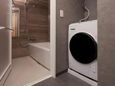 a bathroom with a washing machine and a shower at MIMARU SUITES Tokyo Nihombashi in Tokyo