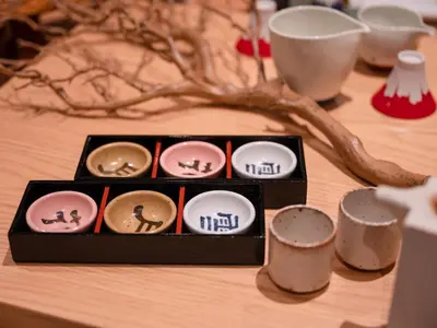 a wooden table with a box of cupcakes on it at MIMARU SUITES Tokyo Nihombashi in Tokyo