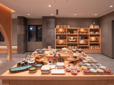 a table with many plates and bowls on it at MIMARU SUITES Tokyo Nihombashi in Tokyo