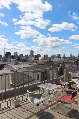 a patio with chairs and a table on a roof at Tokyo Guest House 2020 in Tokyo