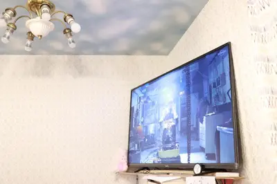a flat screen tv sitting on top of a wall at Tokyo Guest House 2020 in Tokyo